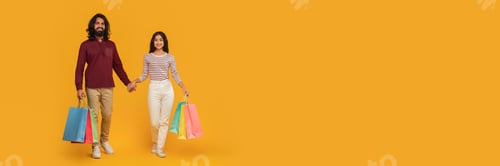 Preview: Positive young indian man and woman with shopping bags