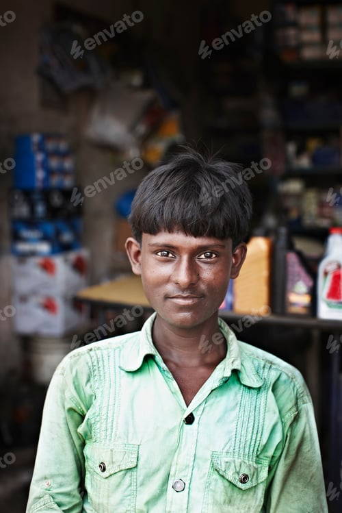 Preview: Smiling man sitting in front of shop