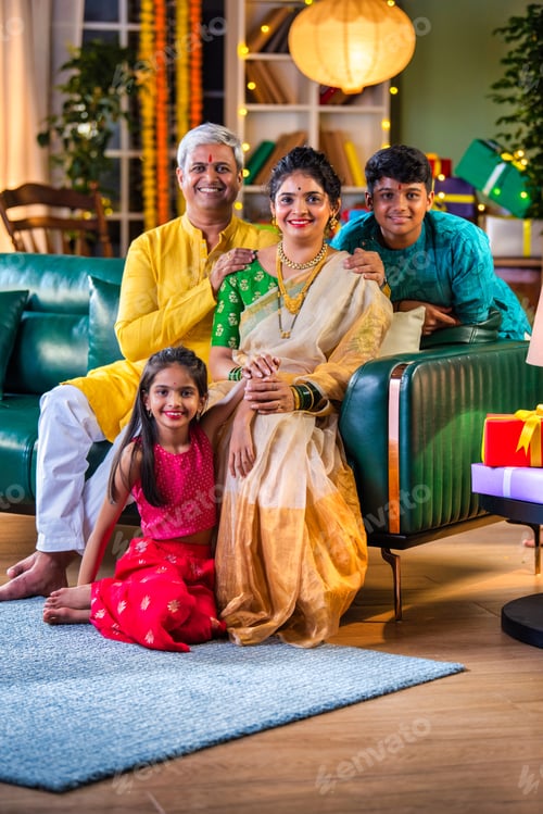 Preview: Indian family siutting with gift box on sofa on diwali festival night
