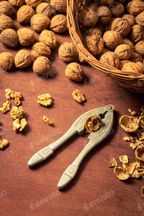 Preview: Cracking walnuts on old wooden table