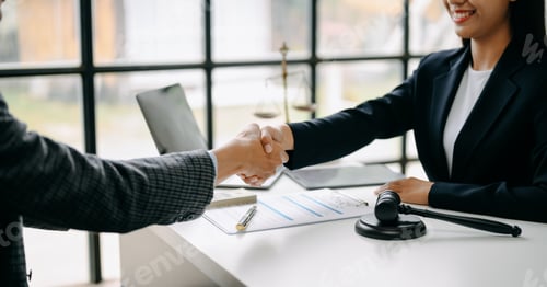 Preview: business people and lawyers discussing contract papers sitting at the table.