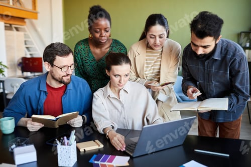 Preview: Group of creative designers making notes while watching online training