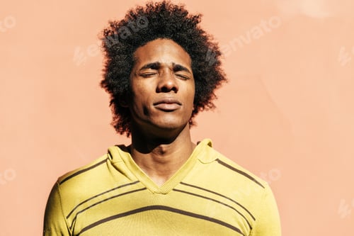 Preview: Cuban black man enjoying the andalusian sun with his eyes closed