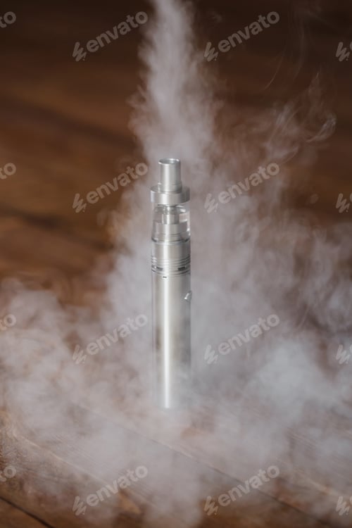 Preview: Electronic cigarette on a wooden table. Smoke.