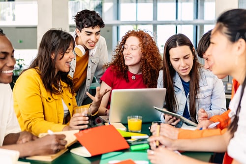 Preview: Group of college people studying together on cafeteria table at campus