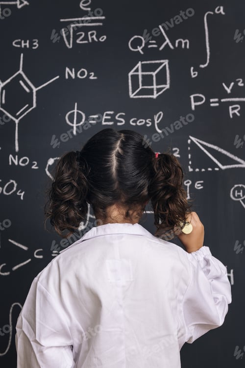 Preview: child scientist in lab coat writing on blackboard