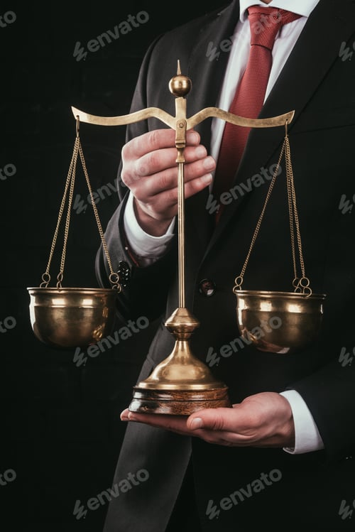 Preview: cropped shot of lawyer holding justice scales isolated on black