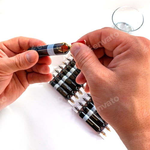 Preview: Group of ampoules with a transparent medicine in medical laboratory.