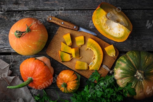 Preview: Raw chopped pumpkin on wooden background