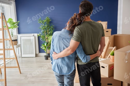 Preview: Rear view of couple looking at new house