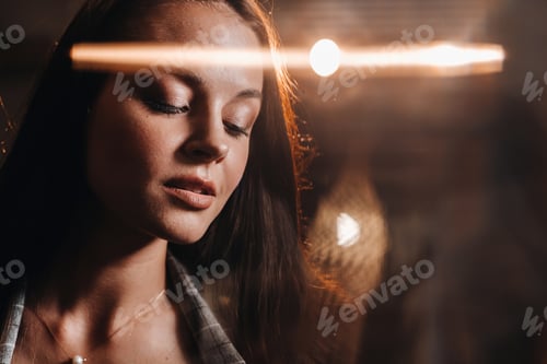 Preview: Portrait of a young European girl with long hair in a coffee shop in the evening light, a tall Girl