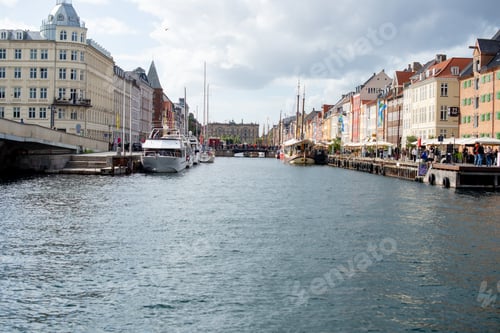 Preview: Scenic river view of vibrant buildings and boats in Copenhagen, Denmark.