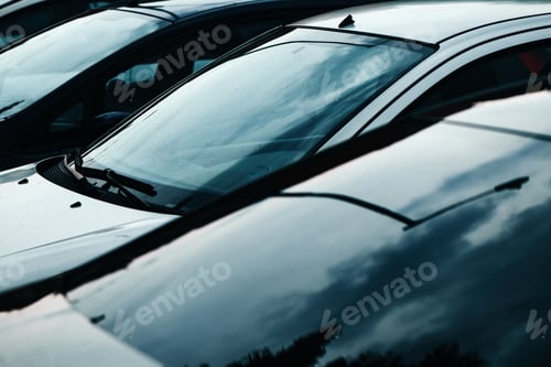 Preview: Car windscreen glass reflecting overcast sky