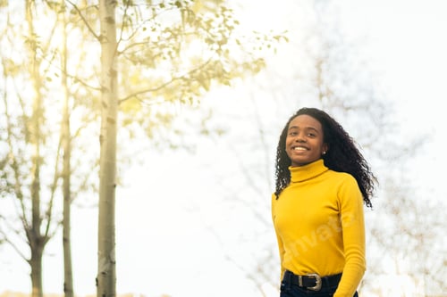 Preview: african american girl walking and smiling in a park