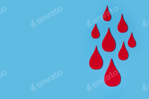 Preview: World hemophilia day concept with red blood drop simbol on blue background