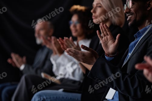 Preview: Smiling Black Man Applauding Speech at Business Conference in Auditorium
