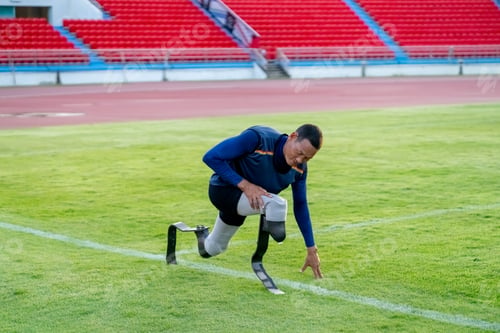 Preview: Asian para-athletes with prosthetic blades sprint on a running track at stadium.