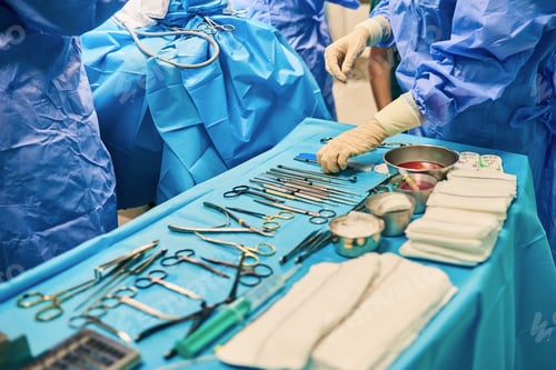 Preview: sterile operating table in the operating room with a variety of surgical tools in a row.