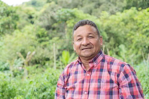 Preview: A farmer smiling while standing in the field