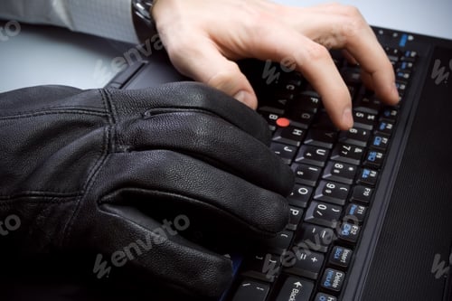 Preview: Computer theft with hands on laptop keyboard