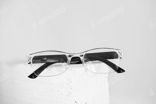 Preview: Stylish eyeglasses on trendy stone. Optical store, glasses selection, eye test