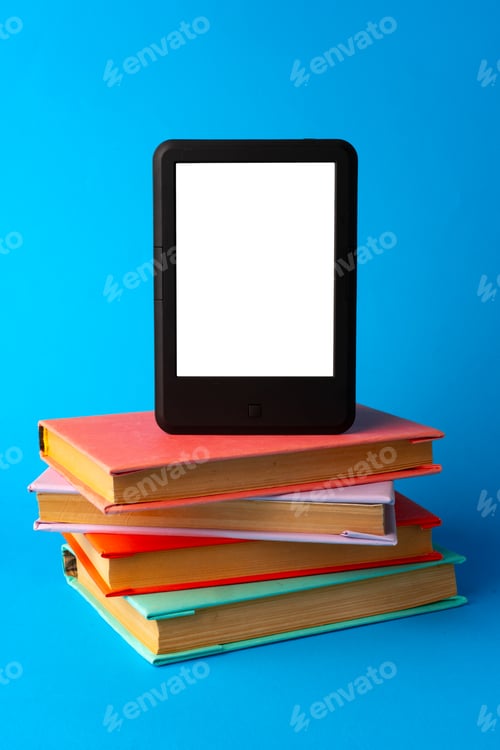 Preview: Modern e-book on stack of hardcover books on blue background