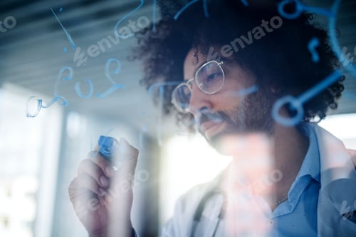 Preview: Doctor making notes in hospital, corona virus concept. Shot through glass