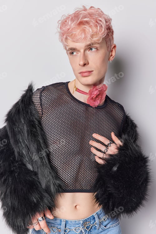 Preview: Vertical shot of pensive fashionable homosexual man looks aside dressed in stylish clothes prepares