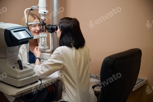 Preview: Ophthalmologist checks the vision of a young blonde woman