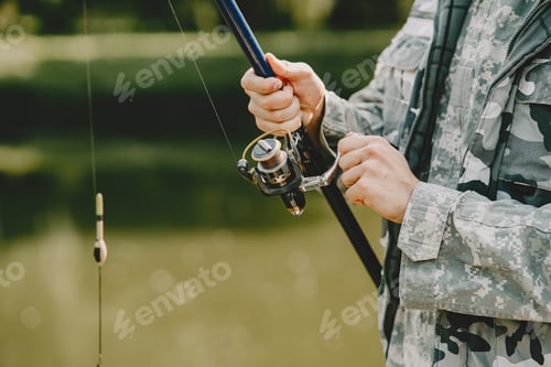 Preview: Man fishing and holds the angling rod