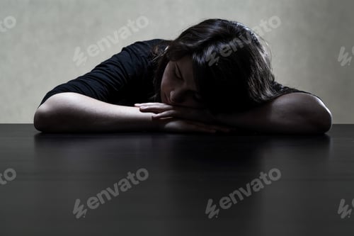 Preview: Pensive And Sad Girl Putting Her Head On The Table, Horizontal
