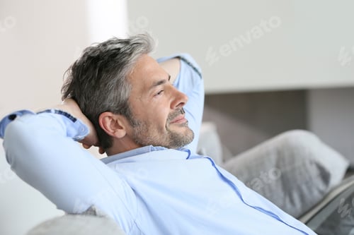 Preview: Middle-Aged Man Having A Restful Moment Relaxing In Sofa
