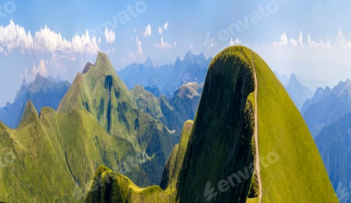 Preview: Panorama of green hills in summer mountains with gravel road for travelling by car