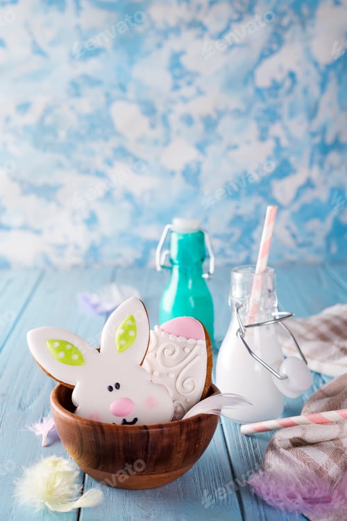 Preview: Easter cookies as rabbit and egg in the wooden bowl with milk in glass on wood background