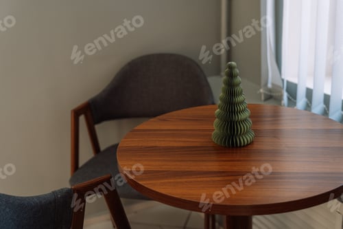 Preview: Artificial small Christmas tree on a round wooden table