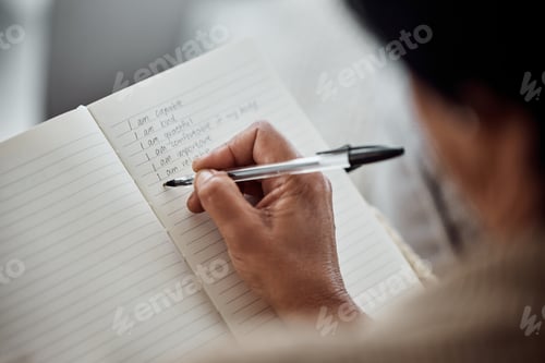 Preview: Hand, book and writing for affirmation with an old woman in her home for support or motivation. Jou