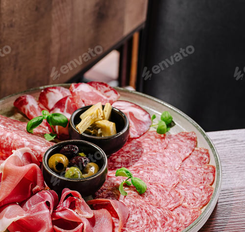 Preview: Delicious charcuterie platter with assorted meats and olives served elegantly