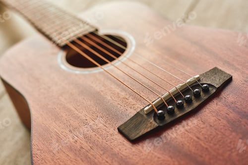 Preview: Romantic guitar music...Close up photo of the brown acoustic guitar lying on the wooden floor