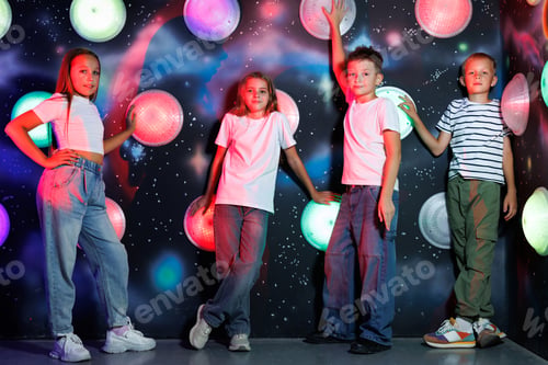 Preview: Four Children Posing Together with Colorful Lights
