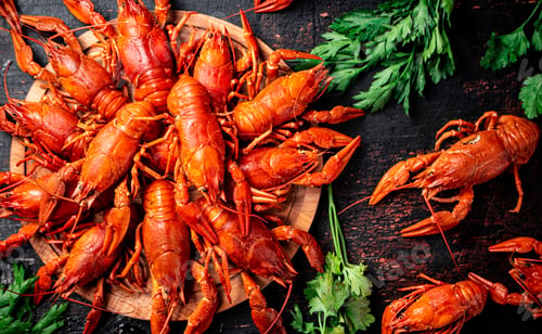 Preview: Boiled crayfish on a wooden cutting board with parsley.