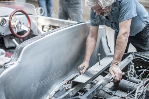 Preview: Senior man restoring a car