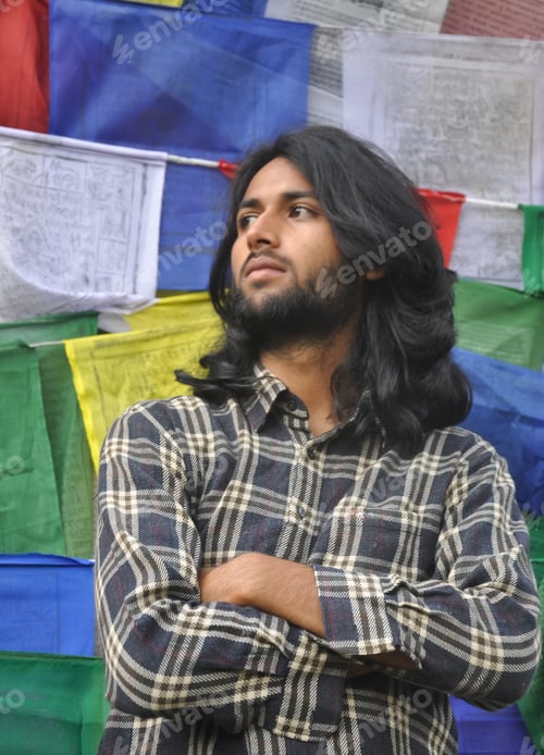 Preview: A good looking young guy looking sideways posing with his arms crossed
