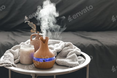 Preview: Spa composition with aroma oil diffuser lamp and candle on a blurred background.