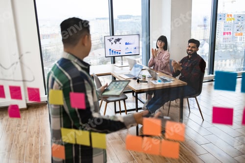 Preview: Business team meeting with presentation and technology in office