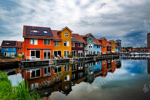 Preview: Colorful houses reflecting in a canal in Groningen, Netherlands.