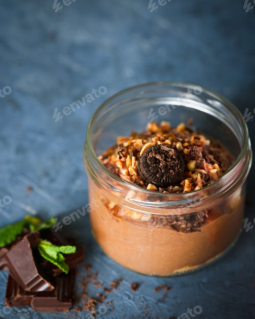 Preview: Delicious dessert chocolate mousse with chocolate cookies, almonds in glass jar