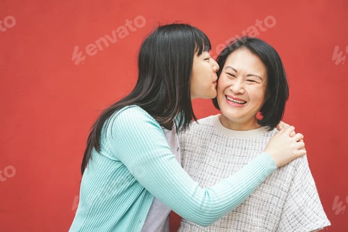 Preview: Happy Asian mother and daughter having fun outdoor