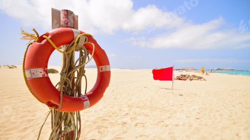 Preview: Life buoy at the beach for safety red flag summer