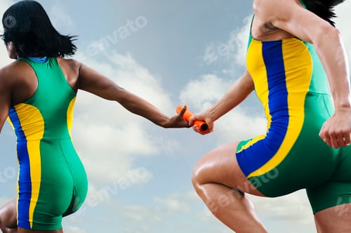 Preview: Two female relay athletes exchanging baton whilst running