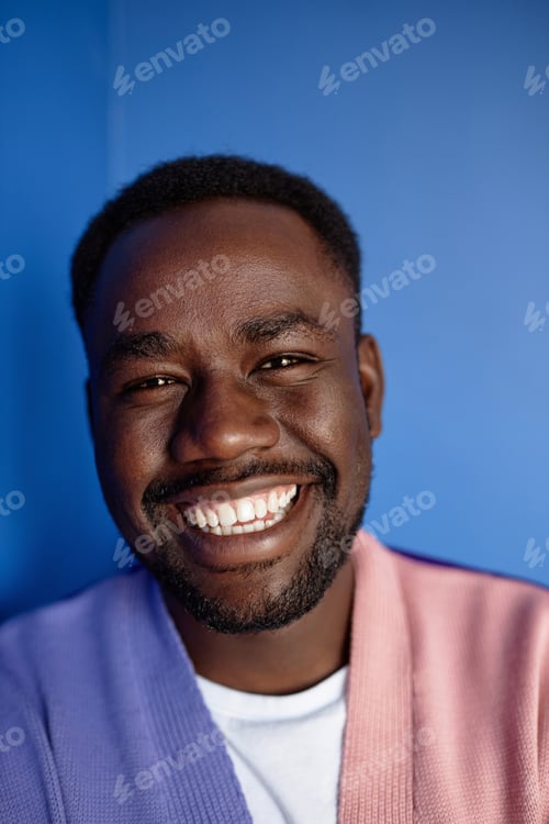 Preview: Closeup black man smiling at camera in vibrant colors